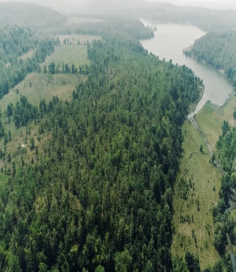 Mangurda setting between hills, forest and lake